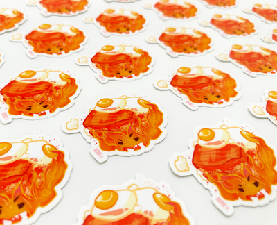 Fire Guy Cooking Bacon and Eggs From an Animated Movie Sticker